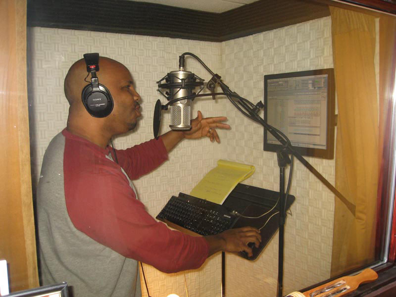 Malik working on vocals in the recording booth. Photo by Marcus C. Eddings, MCE Photography